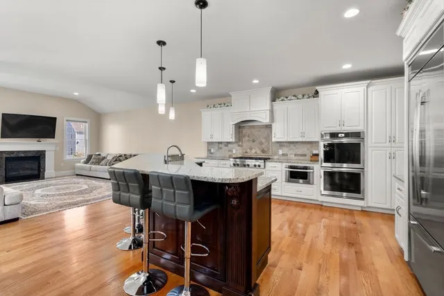 a living room with furniture a rug and a fireplace