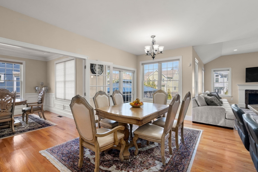 50 Sterling Road Needham, MA 02492 - Photo 8 of 29 a view of a dining room with furniture a chandelier and wooden floor