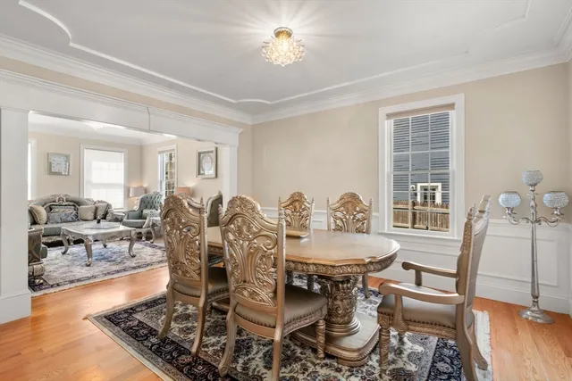 a living room with furniture a wooden floor and a large window