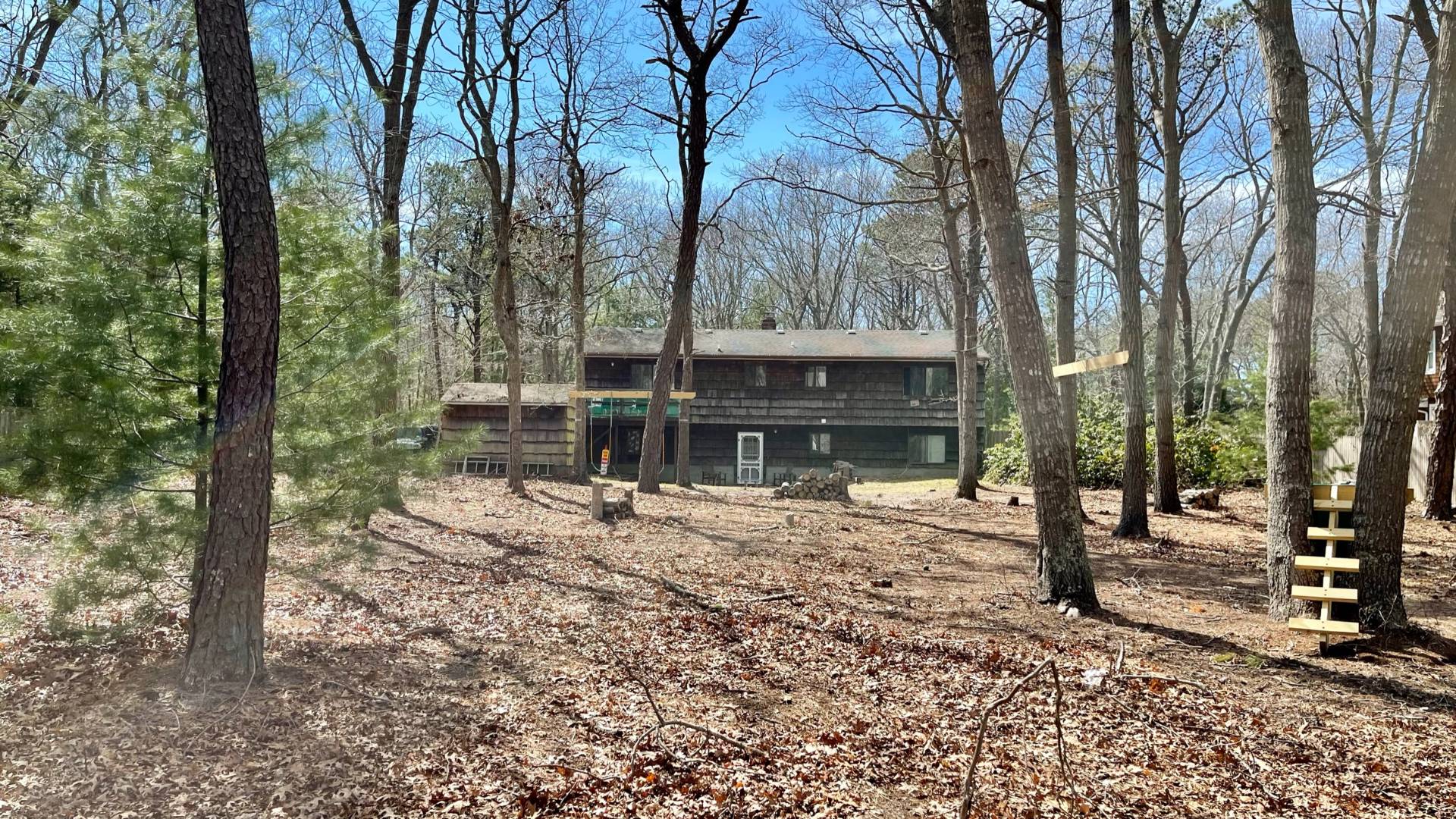 11 Bathgate Road Wainscott, NY 11975 - Photo 12 of 13 a view of a house with trees in the background