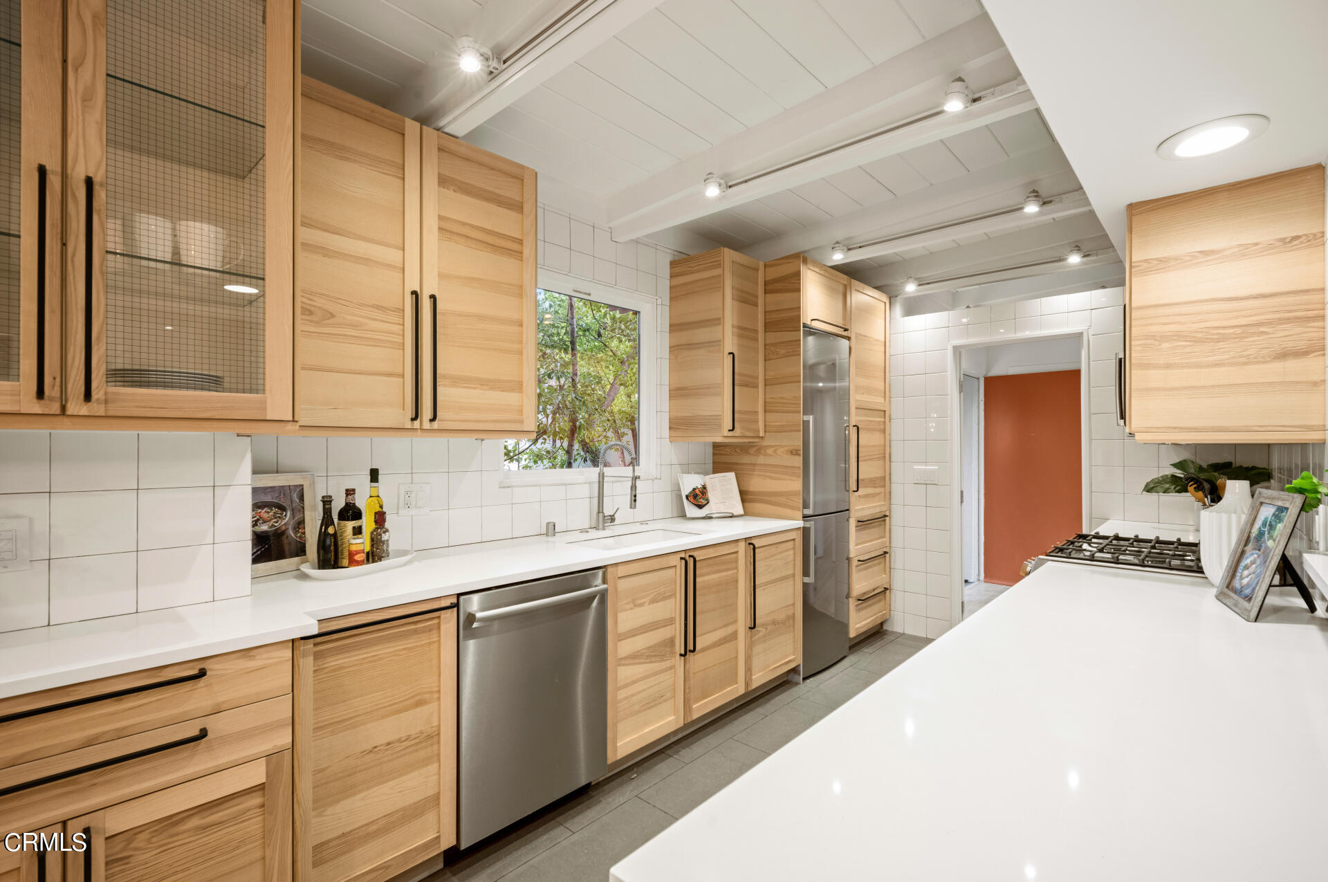 911 Laguna Road Pasadena, CA 91105 - Photo 13 of 34 a kitchen with stainless steel appliances a sink a stove and cabinets