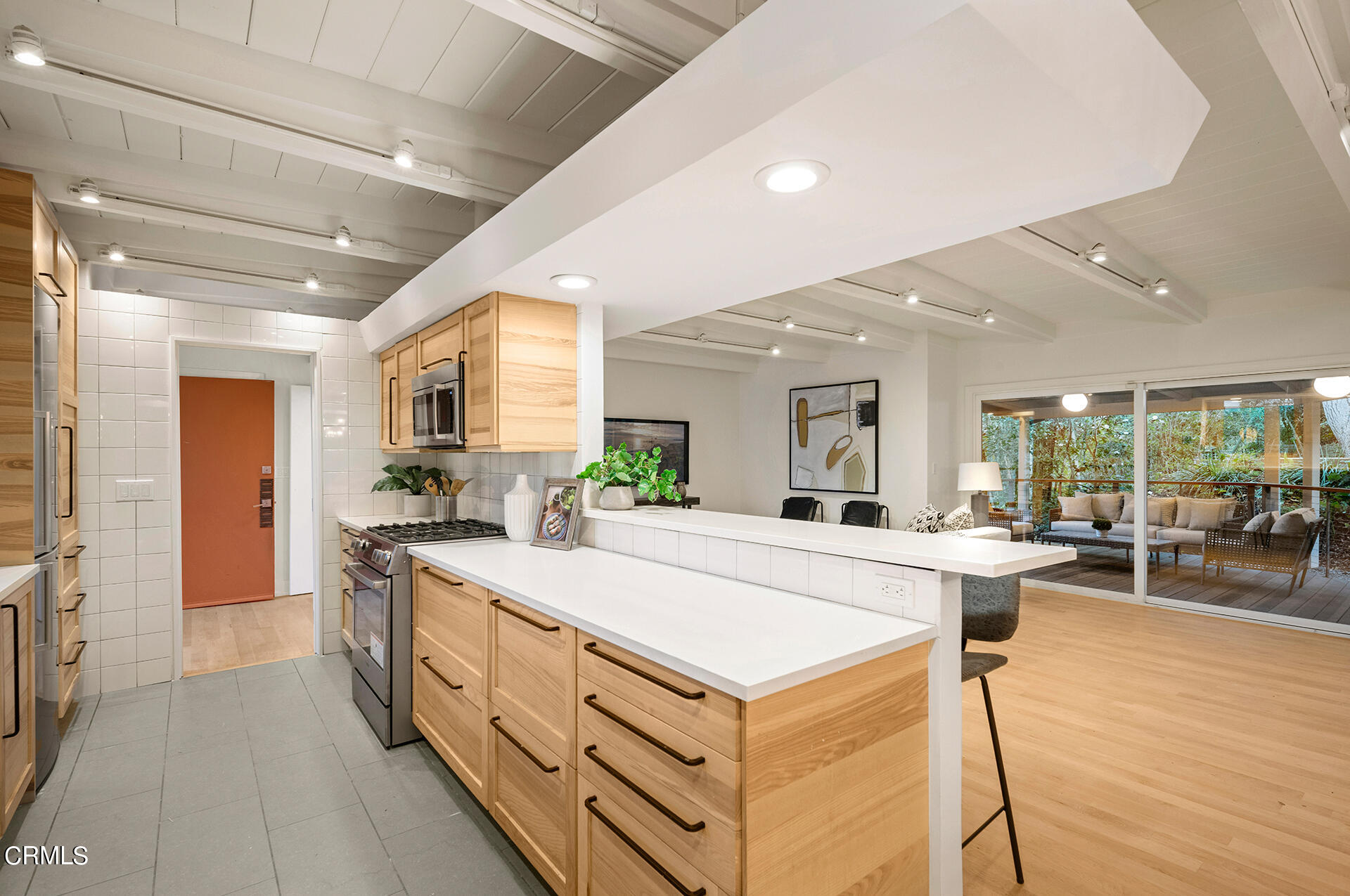 911 Laguna Road Pasadena, CA 91105 - Photo 14 of 34 a large kitchen with kitchen island a large window a sink and stainless steel appliances