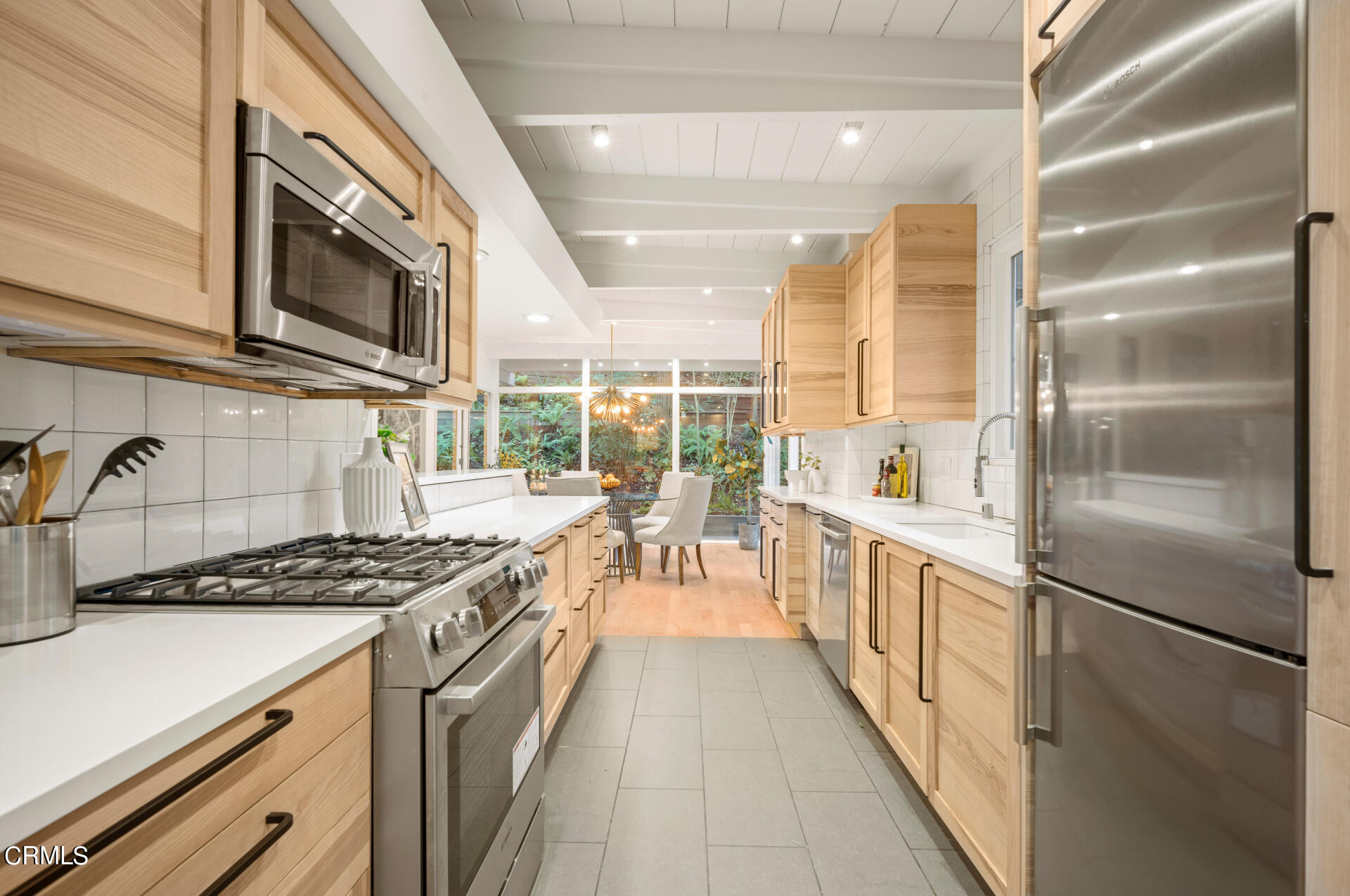 911 Laguna Road Pasadena, CA 91105 - Photo 15 of 34 a kitchen with stainless steel appliances a stove a sink and a refrigerator