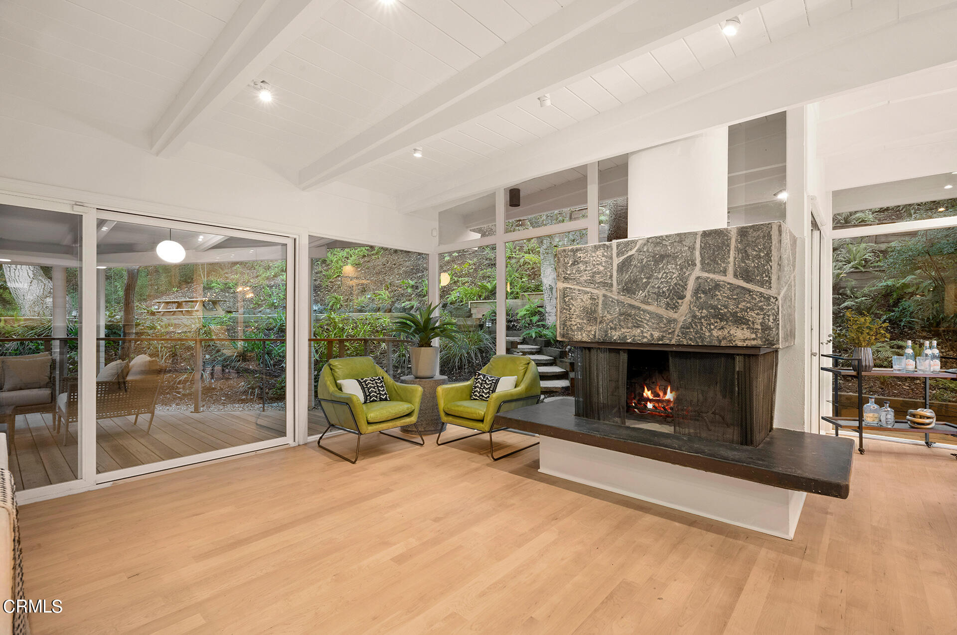 911 Laguna Road Pasadena, CA 91105 - Photo 7 of 34 a living room with furniture a fireplace and a floor to ceiling window