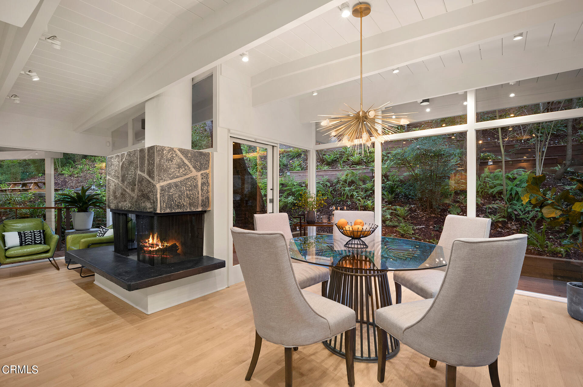 911 Laguna Road Pasadena, CA 91105 - Photo 9 of 34 a living room with furniture a fireplace and a floor to ceiling window