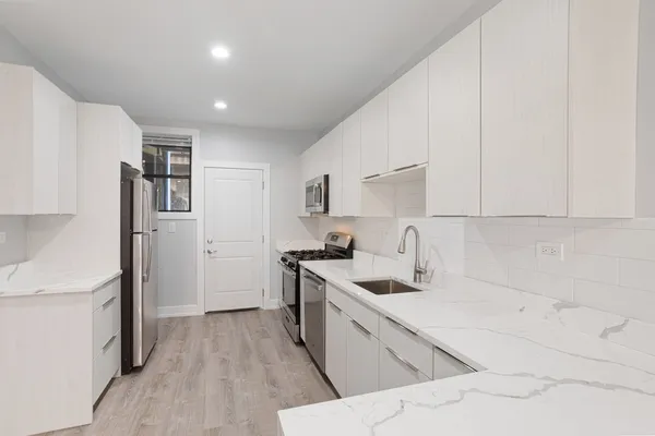 a kitchen with a sink stove and refrigerator