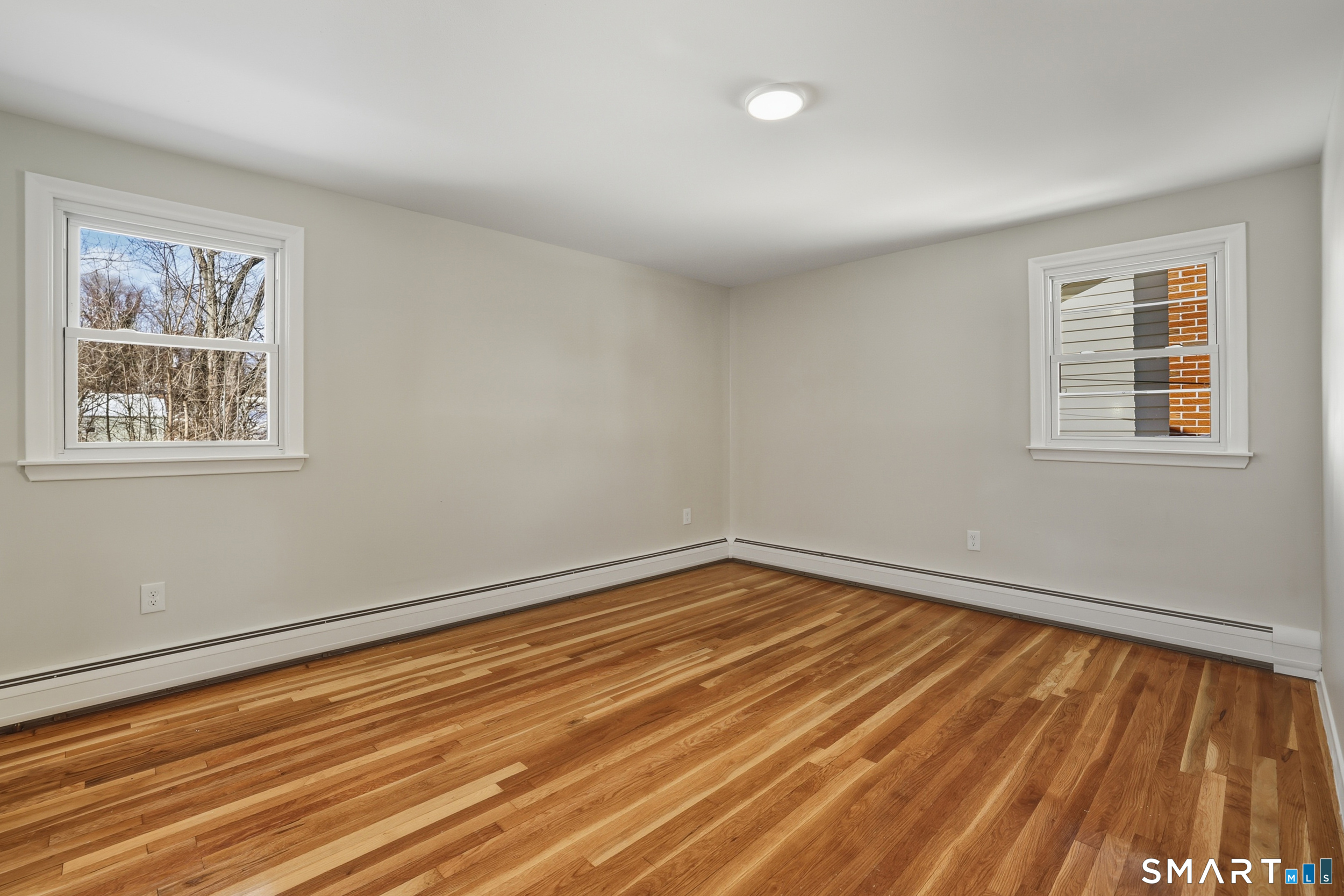 38 Mildred Road West Hartford, CT 06107 - Photo 14 of 35 a view of an empty room with wooden floor and a window