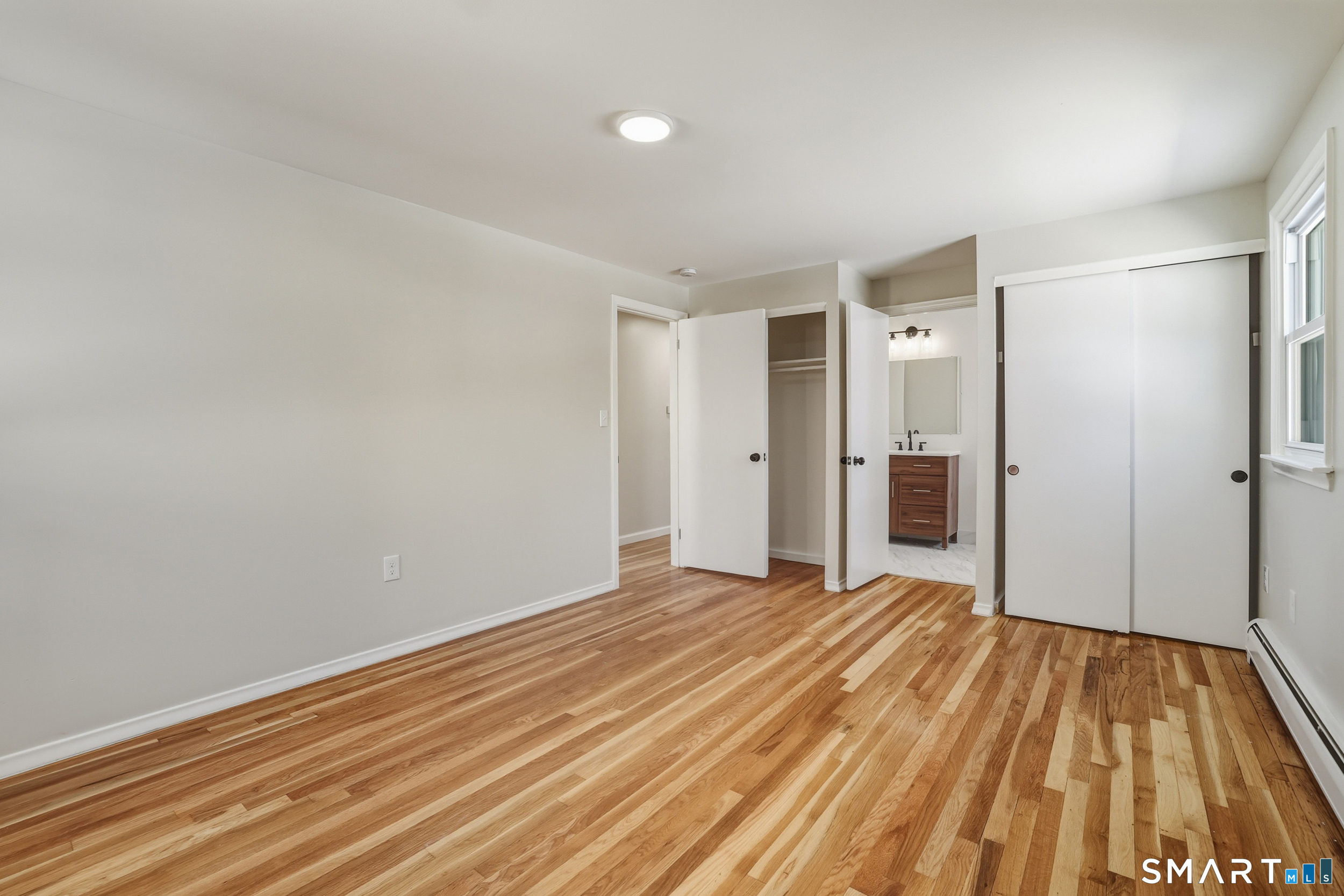 38 Mildred Road West Hartford, CT 06107 - Photo 15 of 35 a view of an empty room with wooden floor and a bathroom