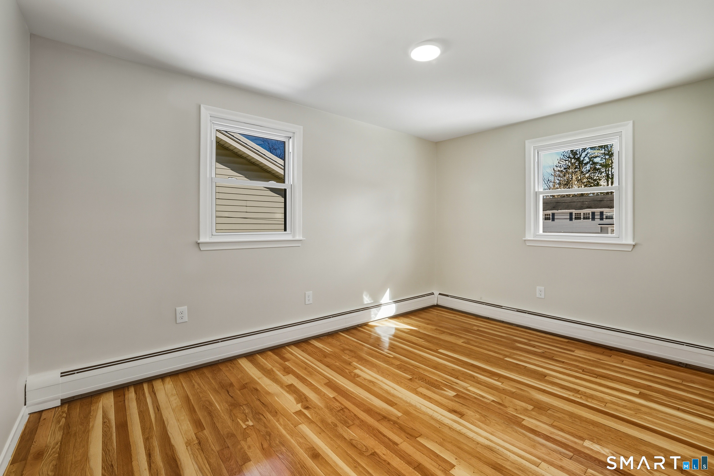 38 Mildred Road West Hartford, CT 06107 - Photo 17 of 35 a view of an empty room with window and wooden floor