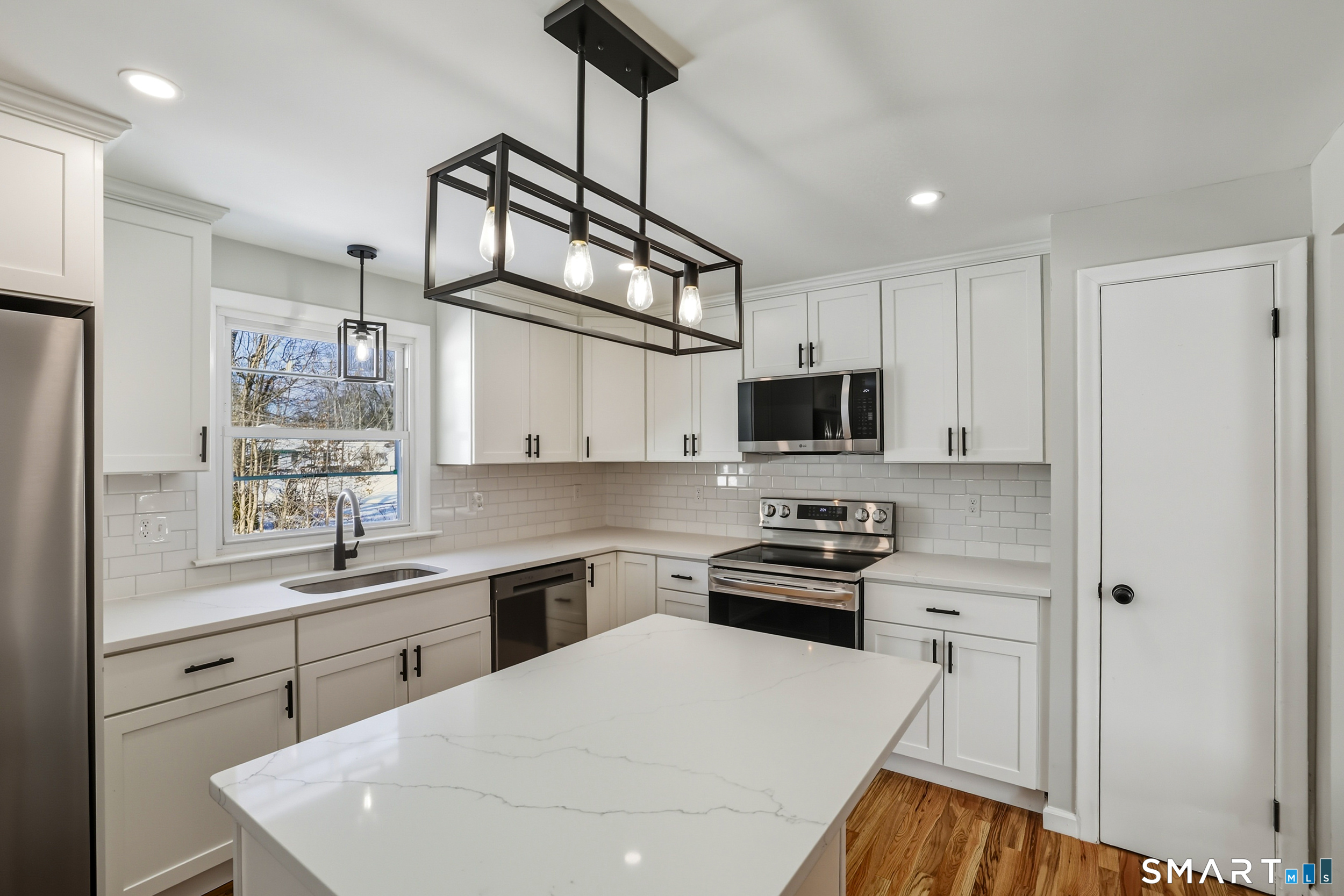 38 Mildred Road West Hartford, CT 06107 - Photo 3 of 35 a kitchen with stainless steel appliances a sink a stove a refrigerator cabinets and a window