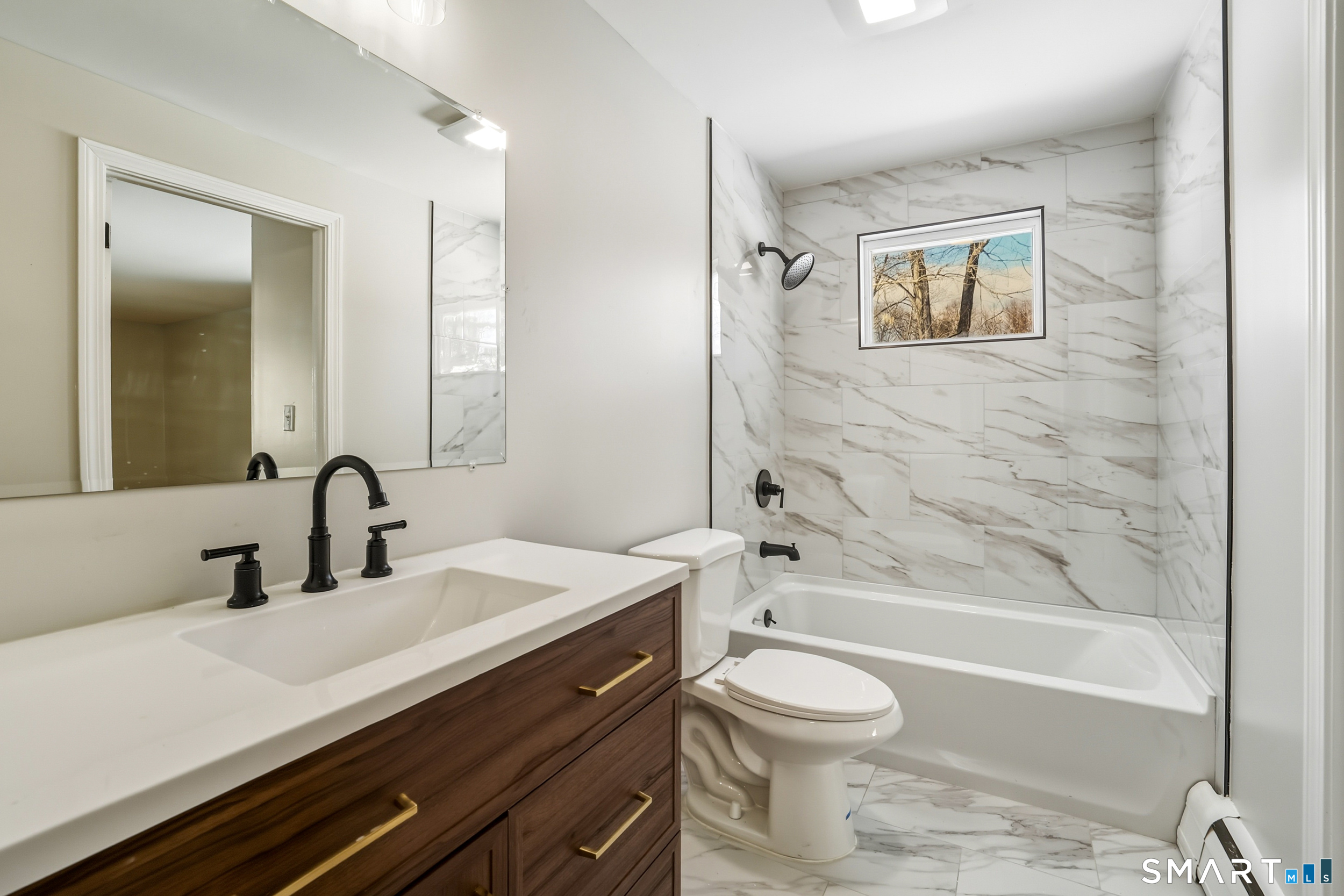 38 Mildred Road West Hartford, CT 06107 - Photo 5 of 35 a bathroom with a bathtub shower sink vanity mirror and toilet