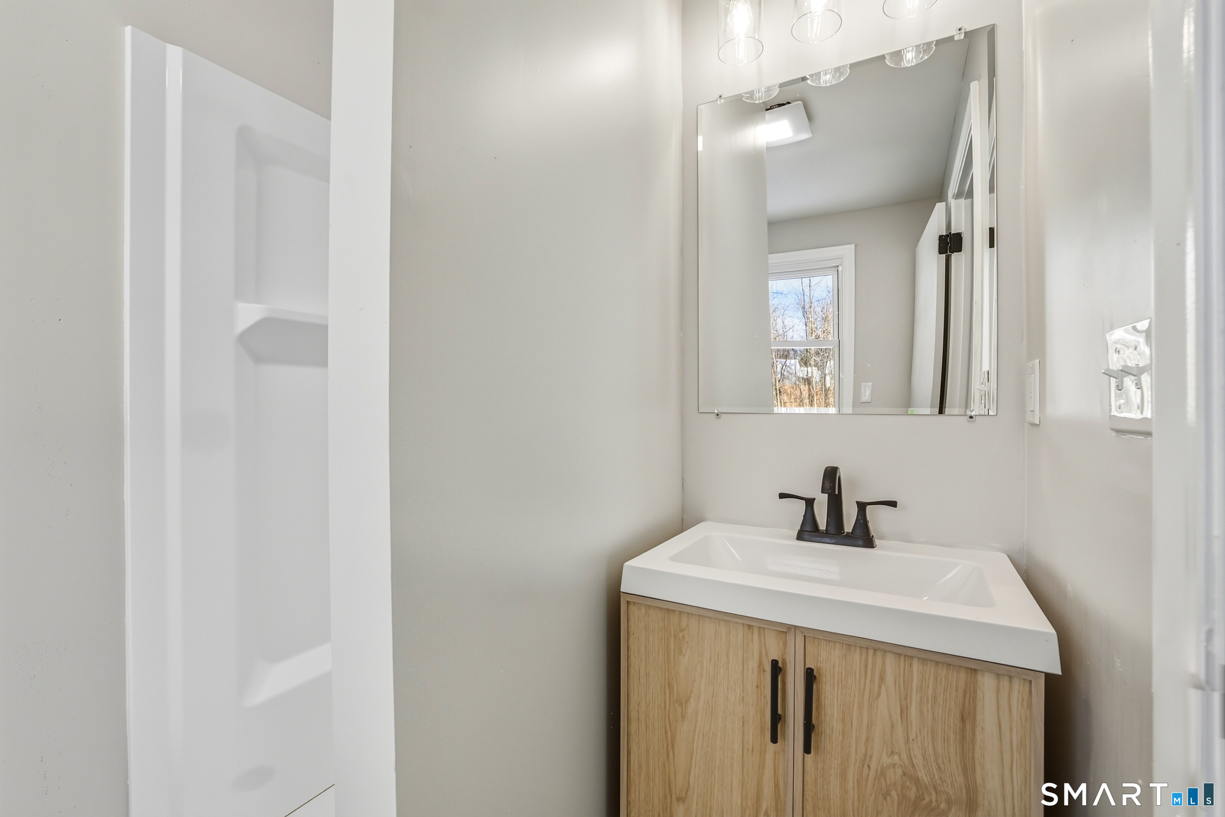 38 Mildred Road West Hartford, CT 06107 - Photo 7 of 35 a bathroom with a sink and a mirror