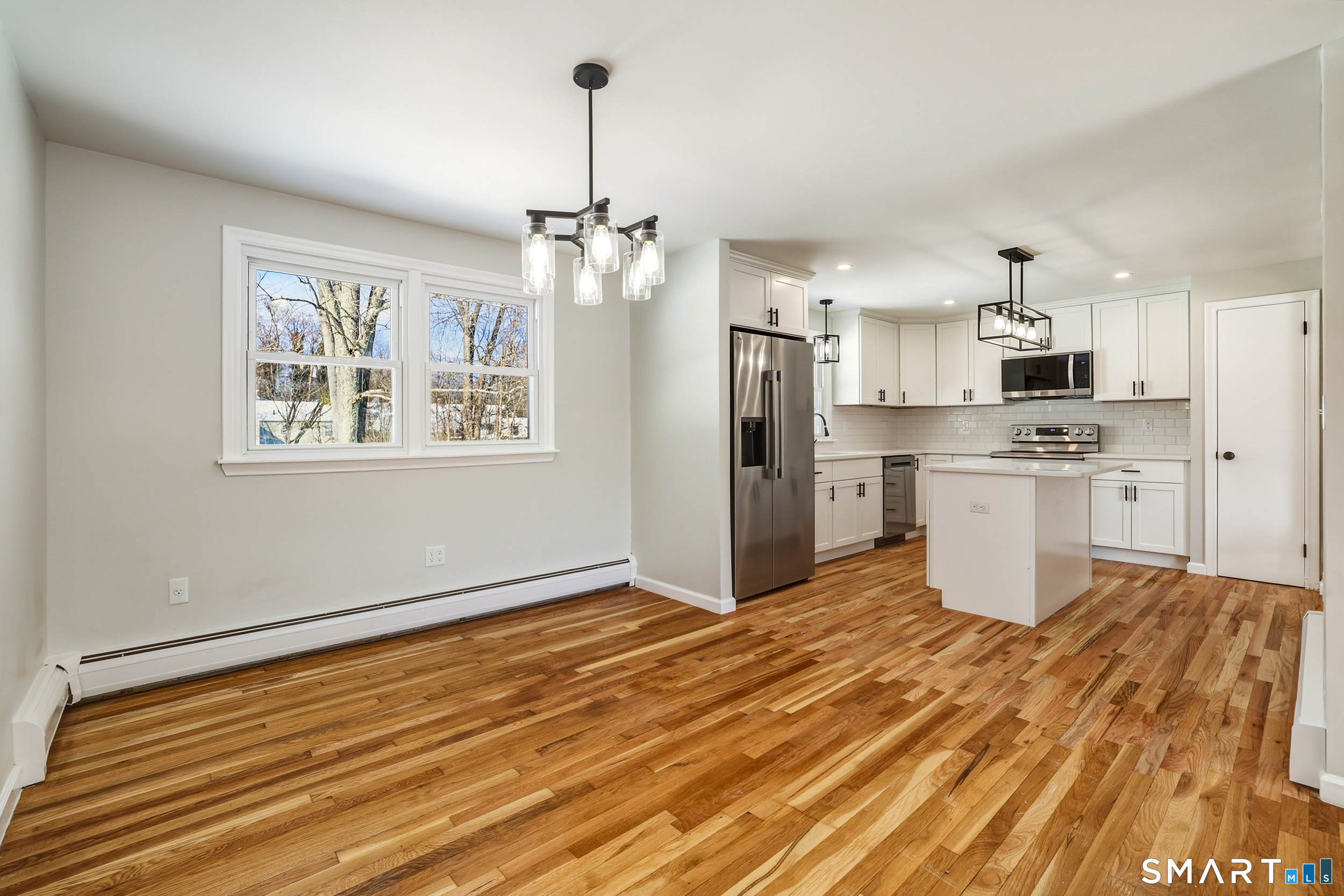 38 Mildred Road West Hartford, CT 06107 - Photo 8 of 35 a kitchen with stainless steel appliances granite countertop a refrigerator a stove oven a sink dishwasher and white cabinets with wooden floor