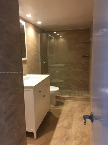 a bathroom with a double vanity sink toilet and shower