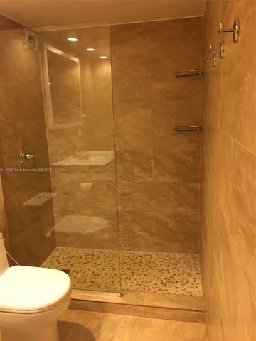 a bathroom with a toilet and a shower