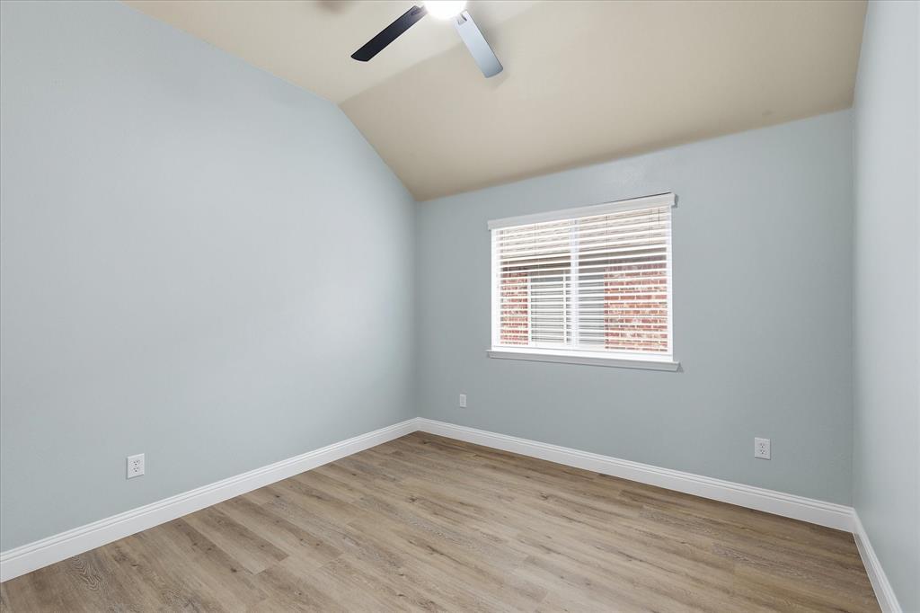 2616 Hollow Ridge Drive Denton, TX 76210 - Photo 28 of 31 Wood-finish flooring throughout, featuring light blue walls and white baseboards