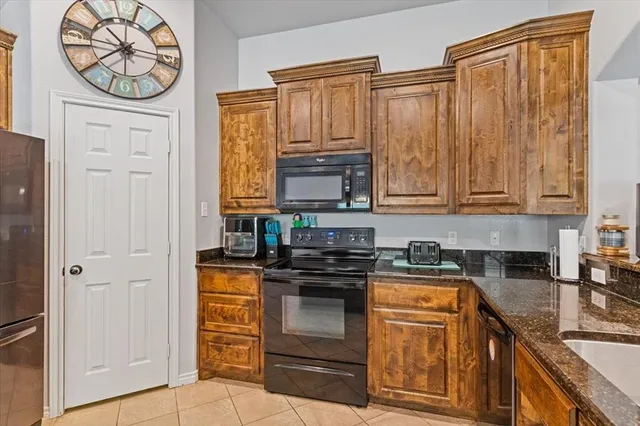 a kitchen with stainless steel appliances granite countertop a stove and a refrigerator