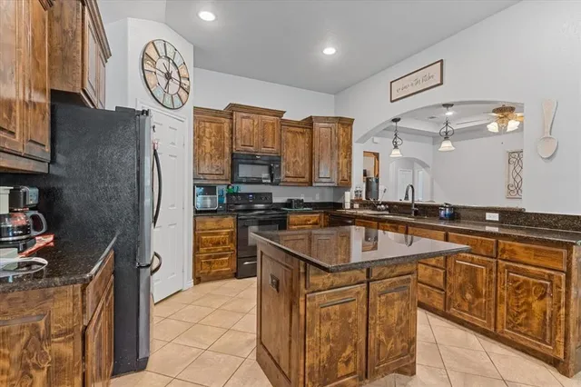 a kitchen with stainless steel appliances granite countertop a sink and cabinets