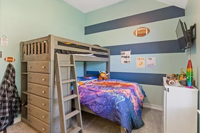 a bed room with a bed and a dresser