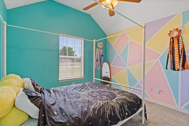 a bed sitting in a bedroom next to a window