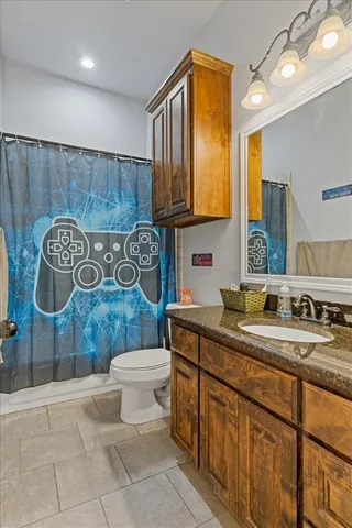 a bathroom with a sink a toilet and mirror