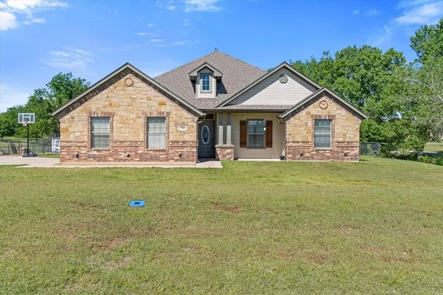 a front view of house with yard and green space