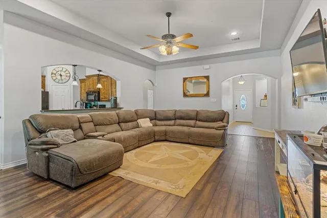 a living room with furniture and a chandelier