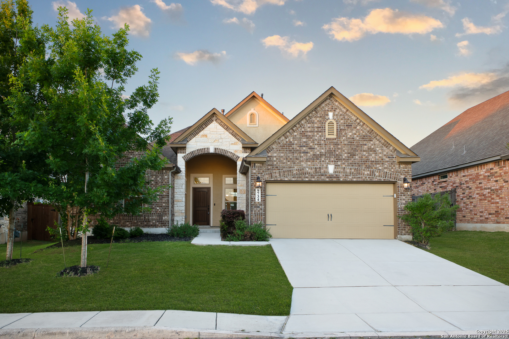 a front view of a house with a yard and garage