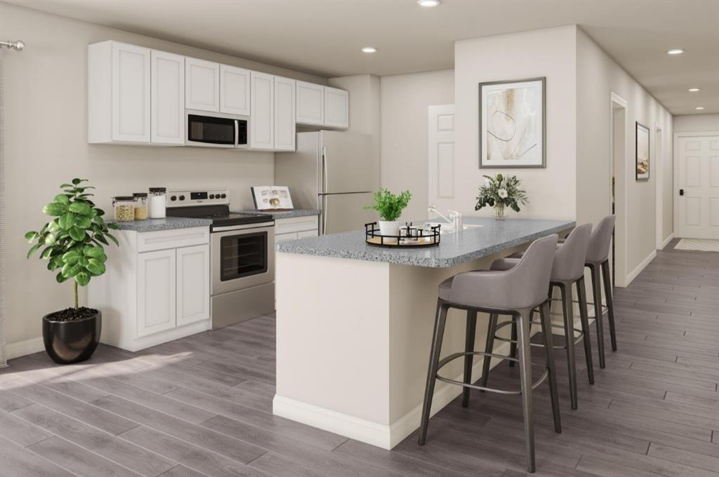 624 Clear Creek Clyde, TX 79510 - Photo 3 of 8 a kitchen with stainless steel appliances a stove a sink a microwave and a potted plant