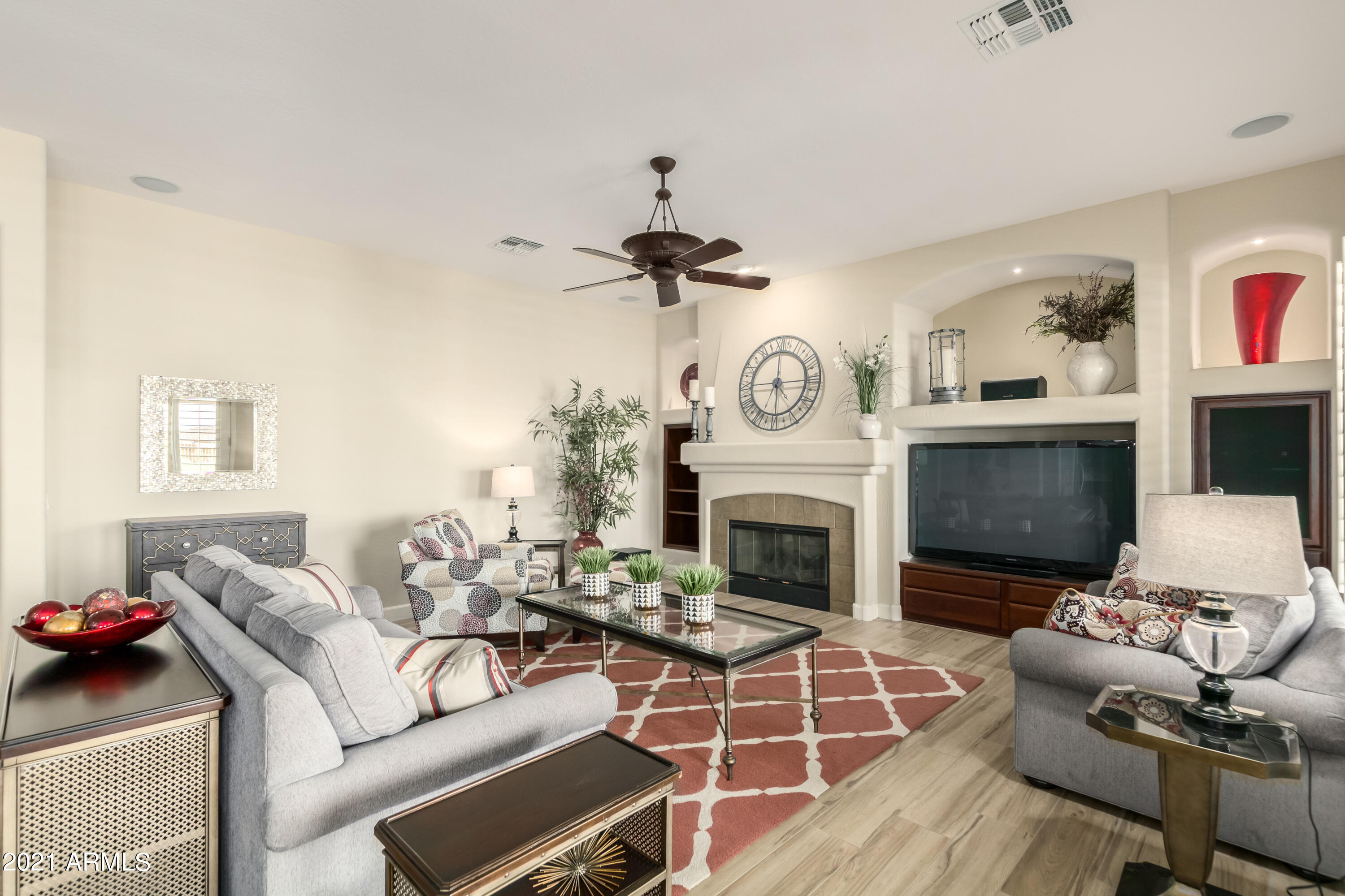 17984 West Narramore Road Goodyear, AZ 85338 - Photo 41 of 149 a living room with furniture a fireplace and a flat screen tv