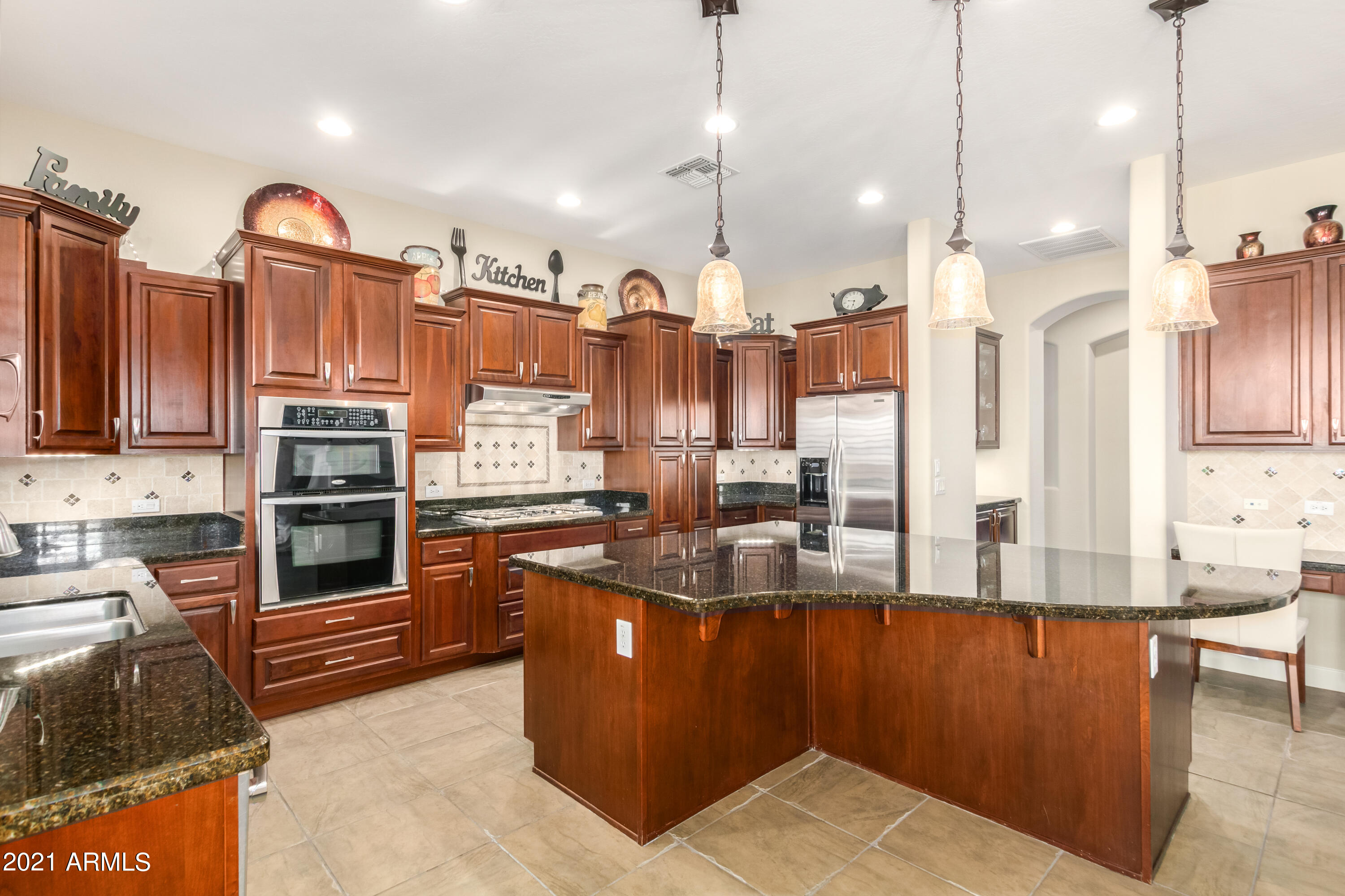 17984 West Narramore Road Goodyear, AZ 85338 - Photo 50 of 149 a kitchen with stainless steel appliances granite countertop a stove a sink and a refrigerator