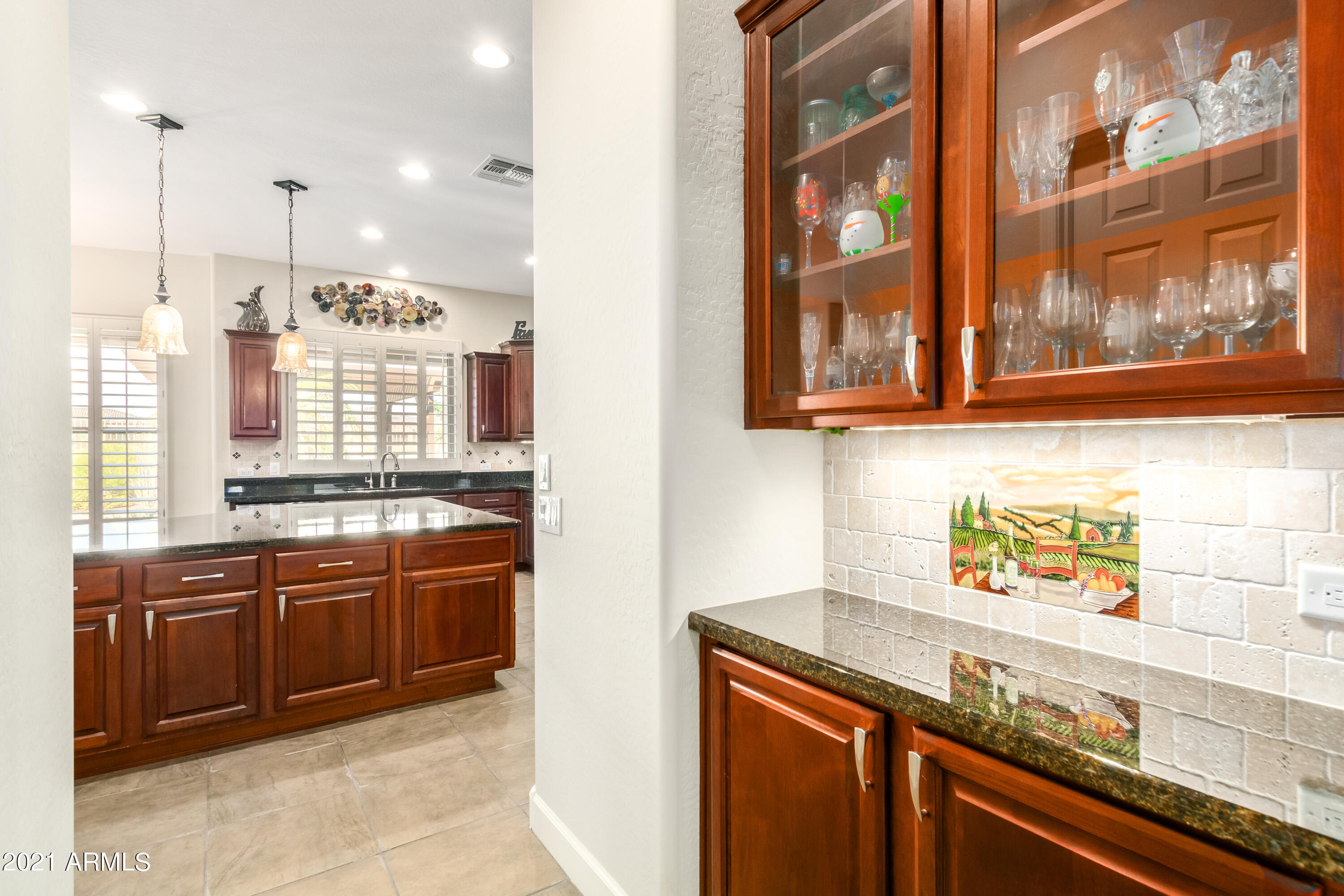 17984 West Narramore Road Goodyear, AZ 85338 - Photo 54 of 149 a kitchen with stainless steel appliances granite countertop a sink and wooden cabinets