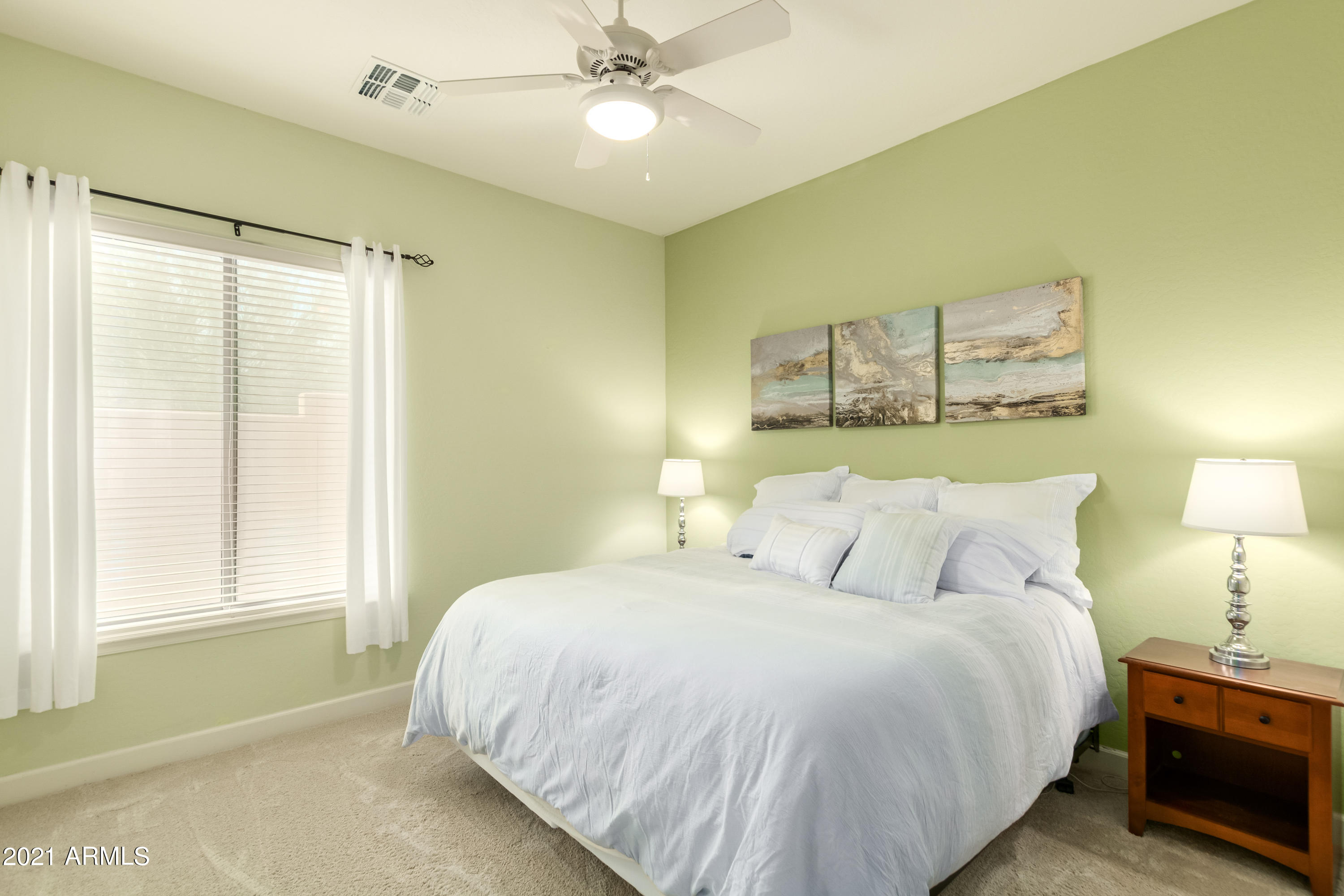 17984 West Narramore Road Goodyear, AZ 85338 - Photo 72 of 149 a bedroom with a large bed and a chandelier