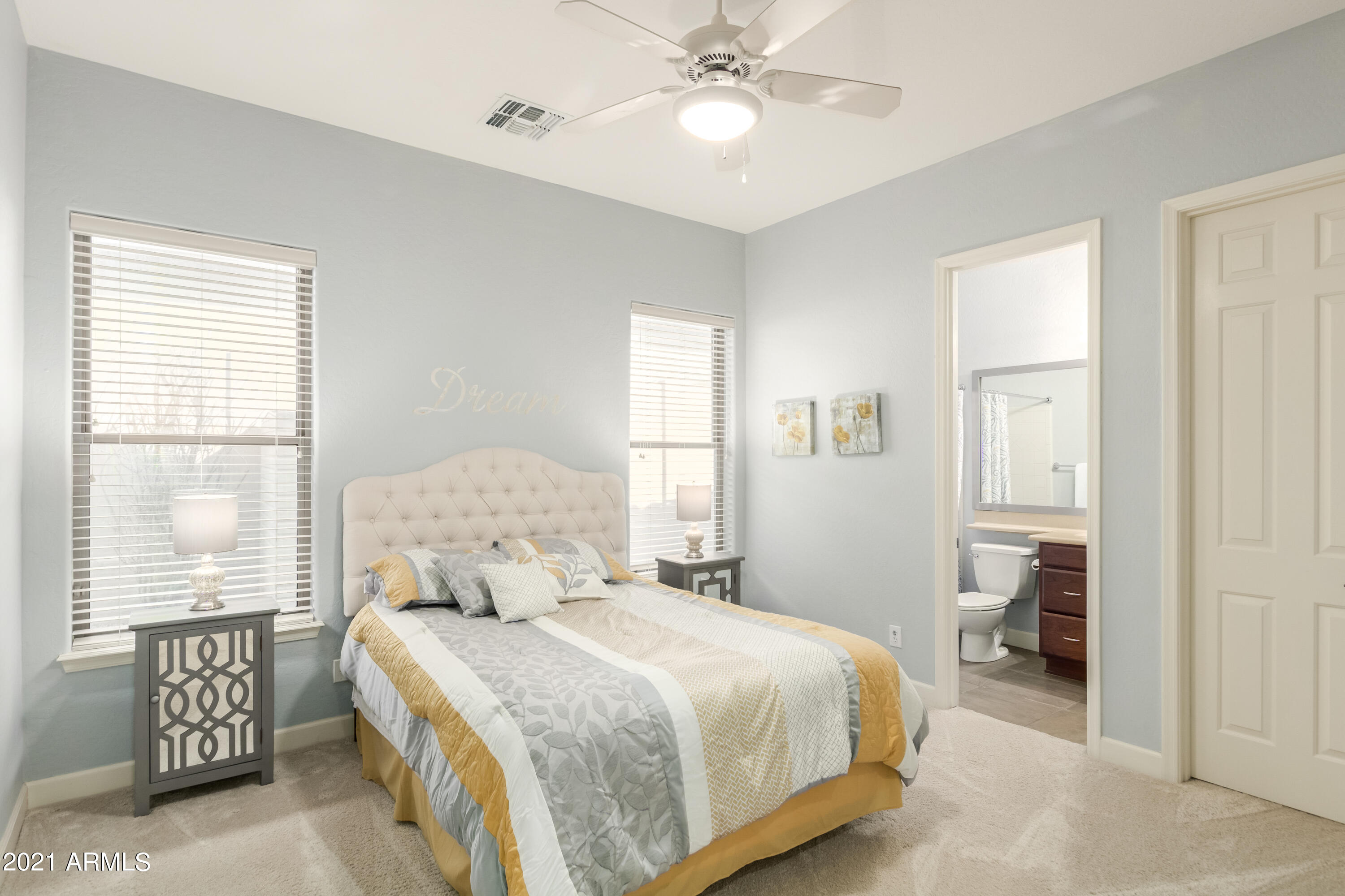 17984 West Narramore Road Goodyear, AZ 85338 - Photo 76 of 149 a bedroom with a large bed and a chandelier