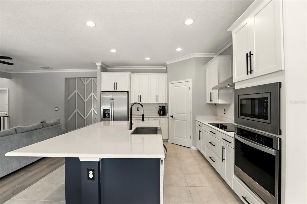 726 Porter Rye Avenue DeBary, FL 32713 - Photo 11 of 44 a kitchen with kitchen island a counter top space a sink stainless steel appliances and cabinets