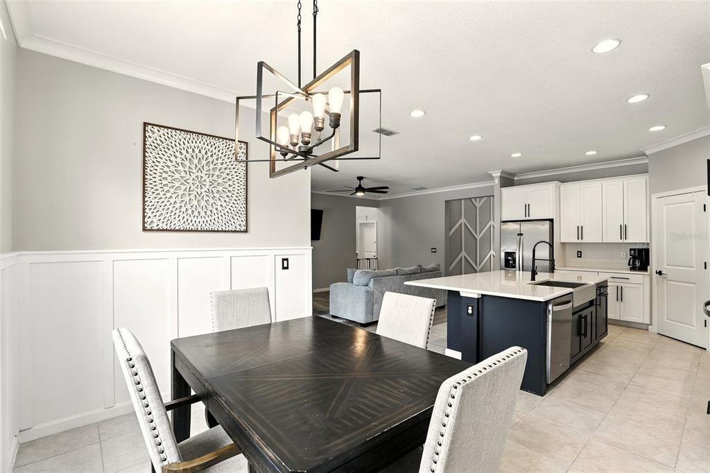 726 Porter Rye Avenue DeBary, FL 32713 - Photo 12 of 44 a room with stainless steel appliances kitchen island a table and chairs in it