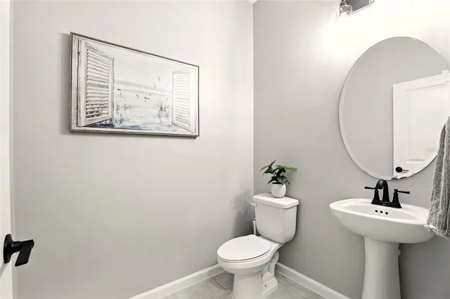 a bathroom with a sink mirror and toilet