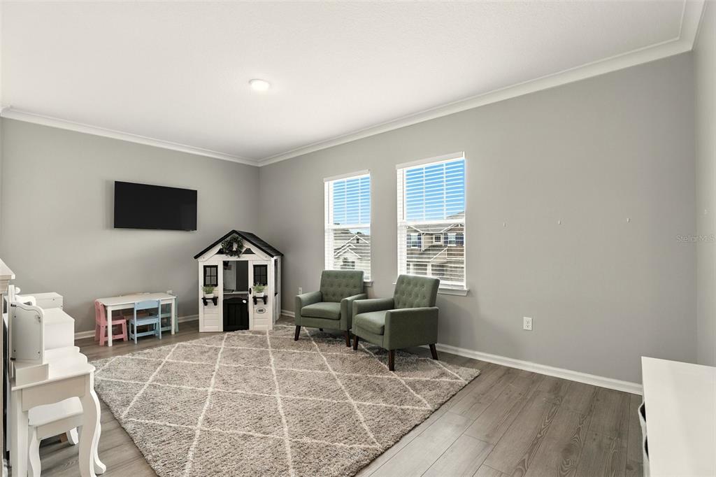726 Porter Rye Avenue DeBary, FL 32713 - Photo 15 of 44 a living room with furniture a flat screen tv and a window