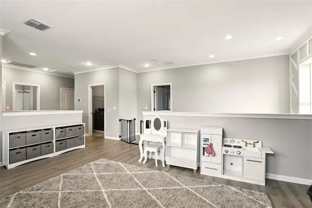 a living room with stainless steel appliances kitchen island granite countertop a sink and cabinets