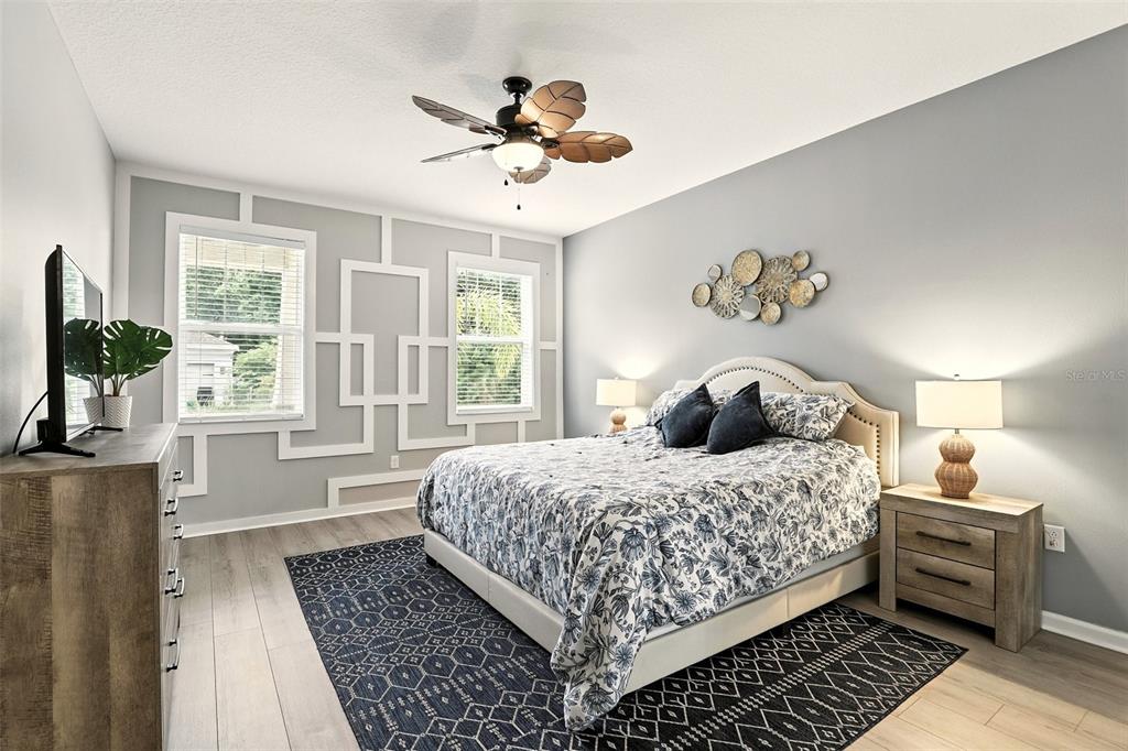 726 Porter Rye Avenue DeBary, FL 32713 - Photo 18 of 44 a bedroom with a bed and a chandelier