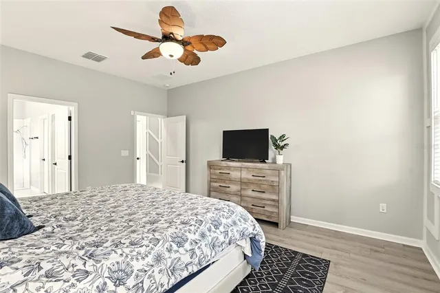 a bedroom with a bed and flat screen tv