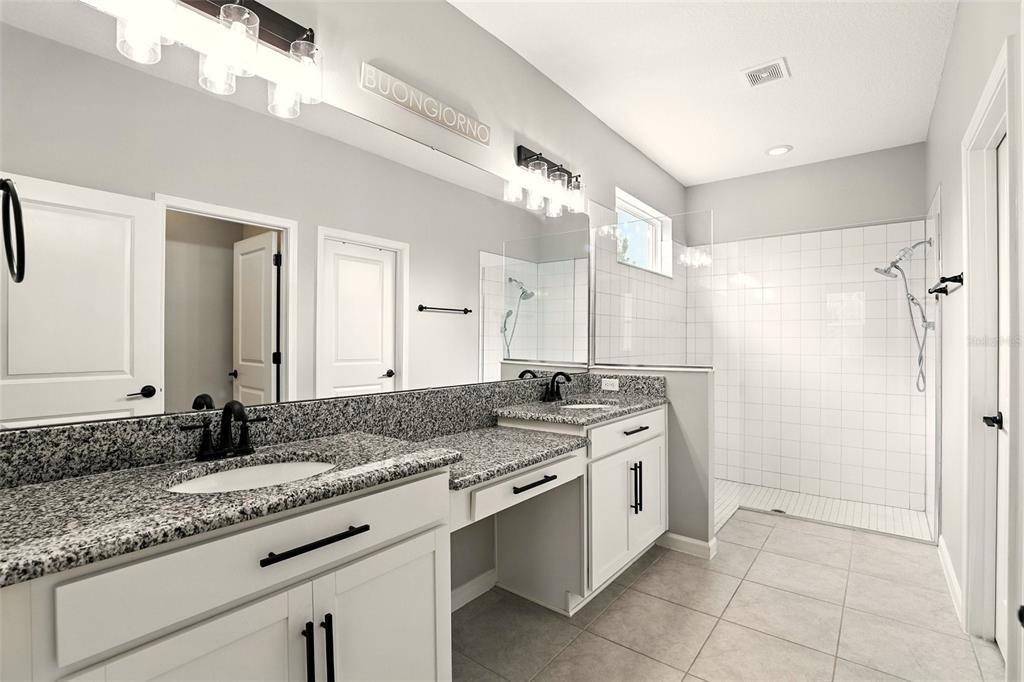 726 Porter Rye Avenue DeBary, FL 32713 - Photo 20 of 44 a spacious bathroom with a granite countertop sink mirror and a