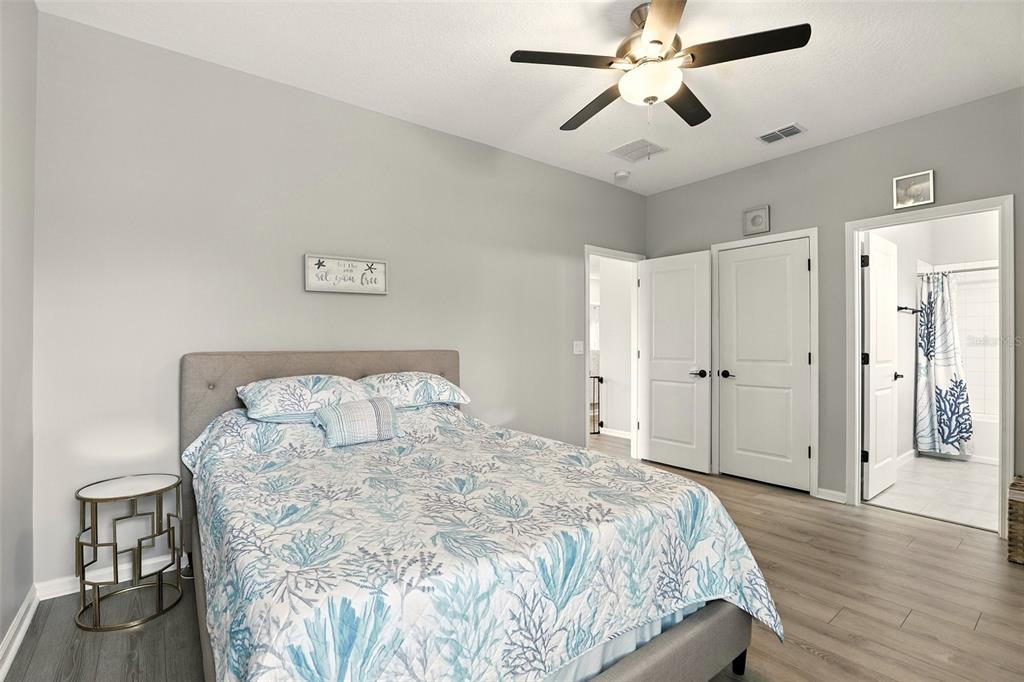 726 Porter Rye Avenue DeBary, FL 32713 - Photo 22 of 44 a spacious bedroom with a bed and a chandelier