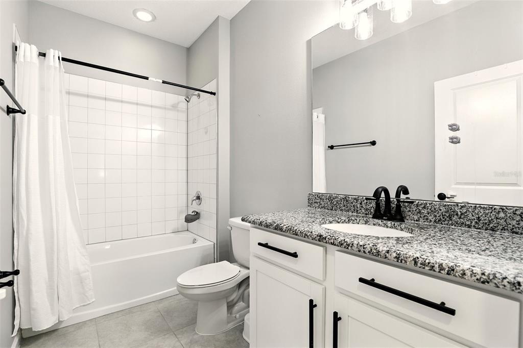 726 Porter Rye Avenue DeBary, FL 32713 - Photo 26 of 44 a bathroom with a granite countertop sink toilet and shower