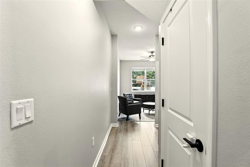 726 Porter Rye Avenue DeBary, FL 32713 - Photo 29 of 44 a view of a hallway to a livingroom with furniture and wooden floor