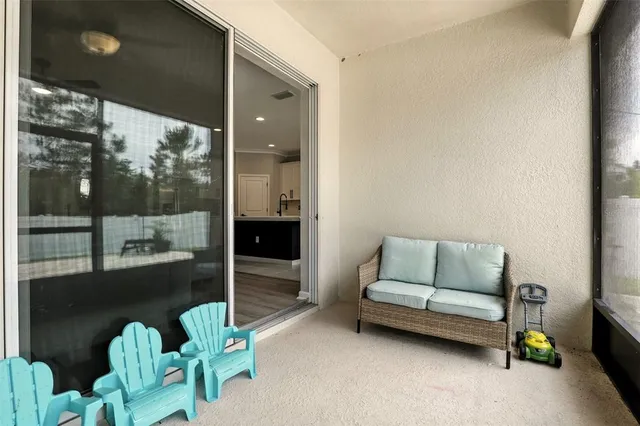 a living room with furniture and a floor to ceiling window