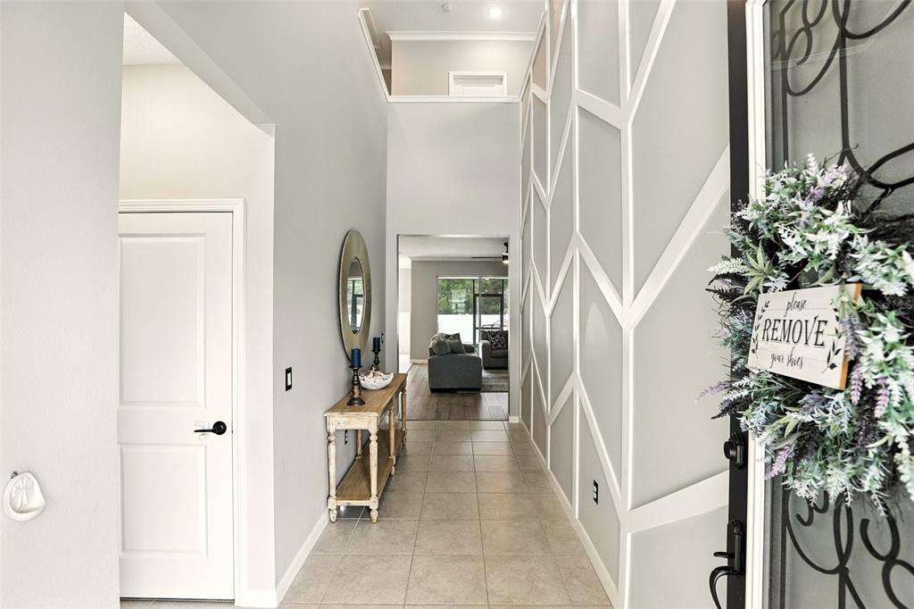 726 Porter Rye Avenue DeBary, FL 32713 - Photo 4 of 44 a view of a hallway with paintings on the wall