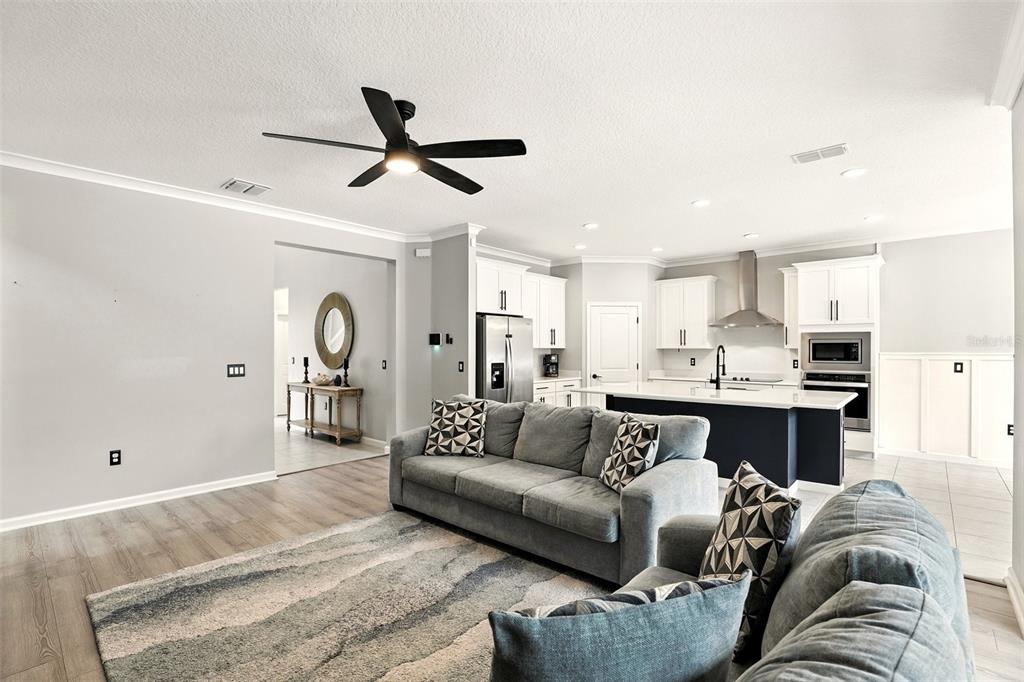 726 Porter Rye Avenue DeBary, FL 32713 - Photo 7 of 44 a living room with a couch and a ceiling fan