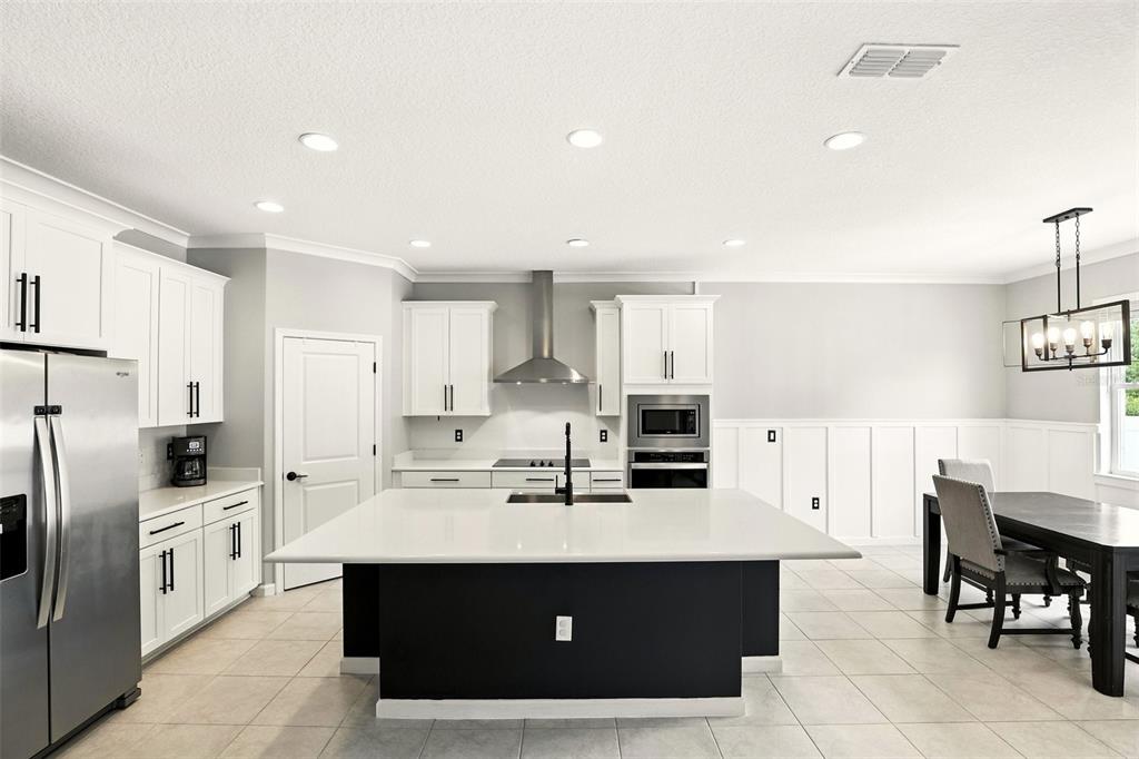 726 Porter Rye Avenue DeBary, FL 32713 - Photo 9 of 44 a kitchen with stainless steel appliances a refrigerator sink and cabinets