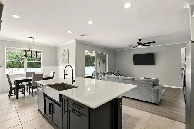 a kitchen with counter top space appliances and windows
